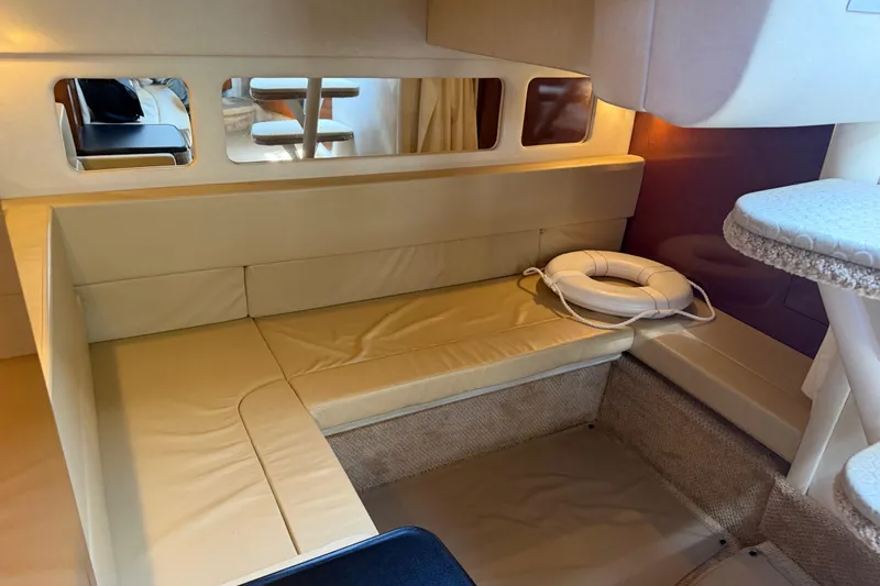 Slide: The Image of Interior of 2008 Sea Ray Sundancer 310 with beige seating and life preserver. - 40