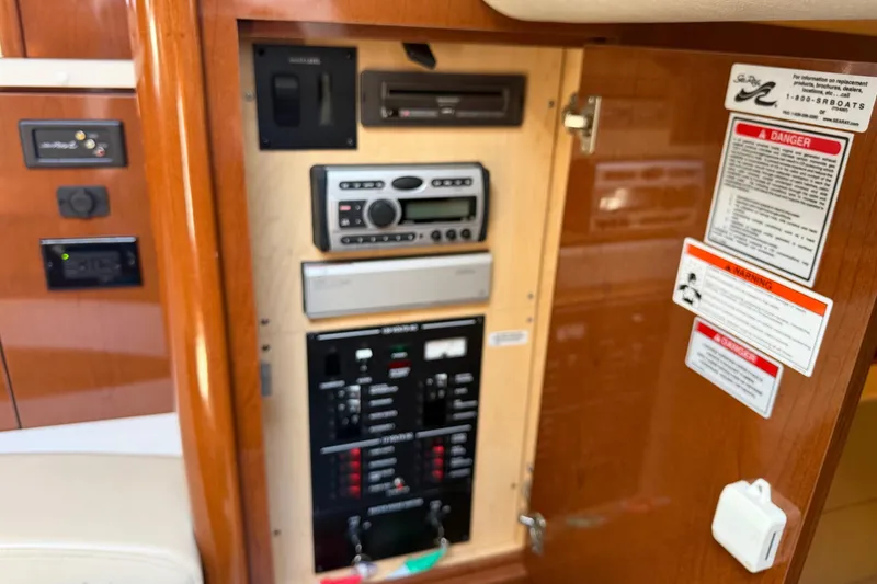 Slide: The Image of 2008 Sea Ray Sundancer 310 control panel with audio system and safety warnings. - 41