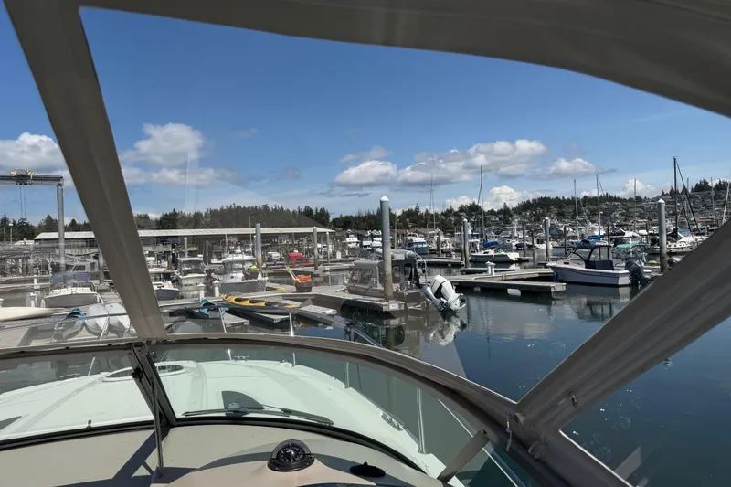 Slide: The Image of 2008 Sea Ray Sundancer 310 docked at a marina under a clear blue sky. - 49