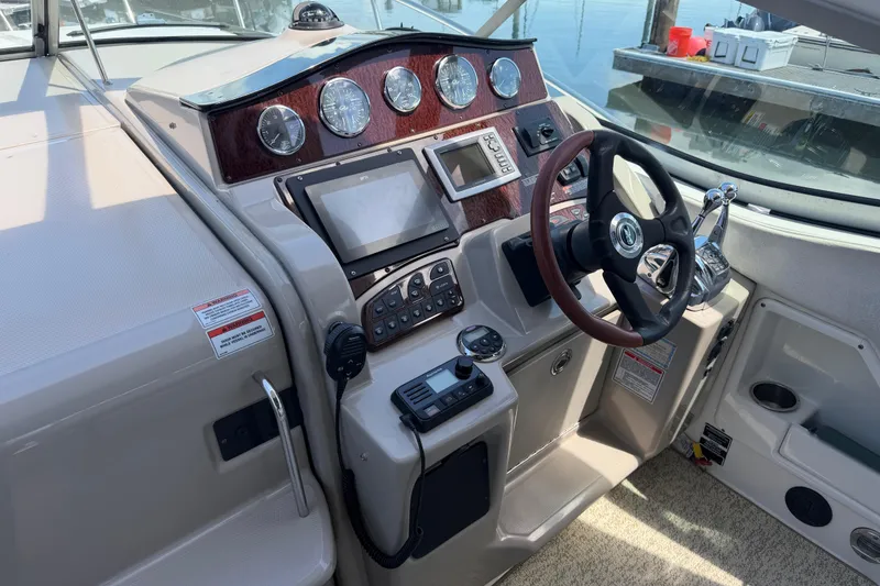 Slide: The Image of Cockpit of 2008 Sea Ray Sundancer 310 with steering wheel and navigation controls. - 5