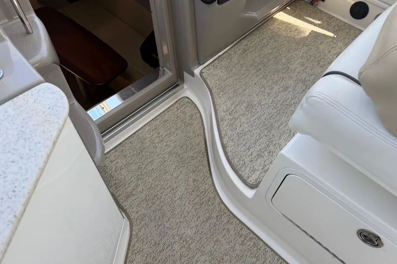 Slide: The Image of Interior view of a 2008 Sea Ray Sundancer 310 boat with carpeted flooring. - 53