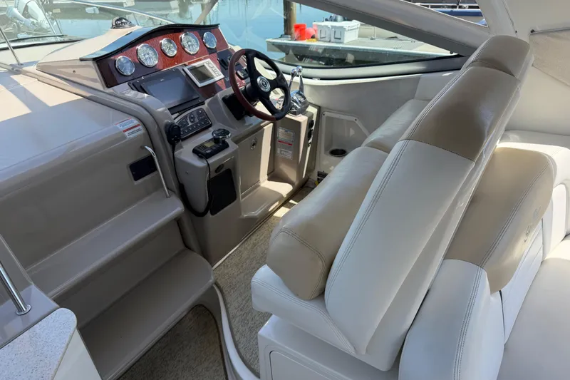 Slide: The Image of 2008 Sea Ray Sundancer 310 cockpit with steering wheel and control panel. - 6