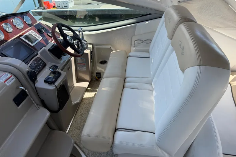 Slide: The Image of Interior of 2008 Sea Ray Sundancer 310 boat with white seating and control panel. - 7