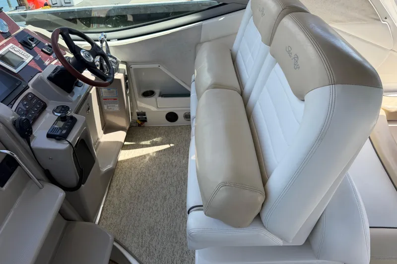 Slide: The Image of 2008 Sea Ray Sundancer 310 cockpit with beige leather seating and modern controls. - 8