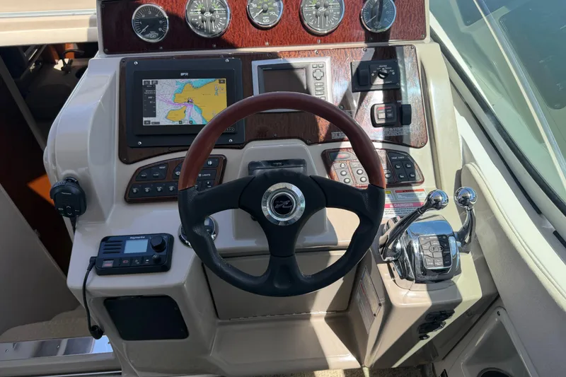 Slide: The Image of Cockpit of 2008 Sea Ray Sundancer 310 with steering wheel, gauges, and navigation system. - 9