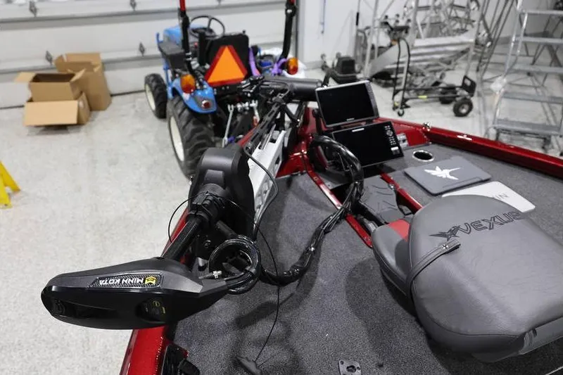 Slide: The Image of 2026 Vexus AVX 2100 boat interior with advanced navigation equipment in a garage setting. - 11