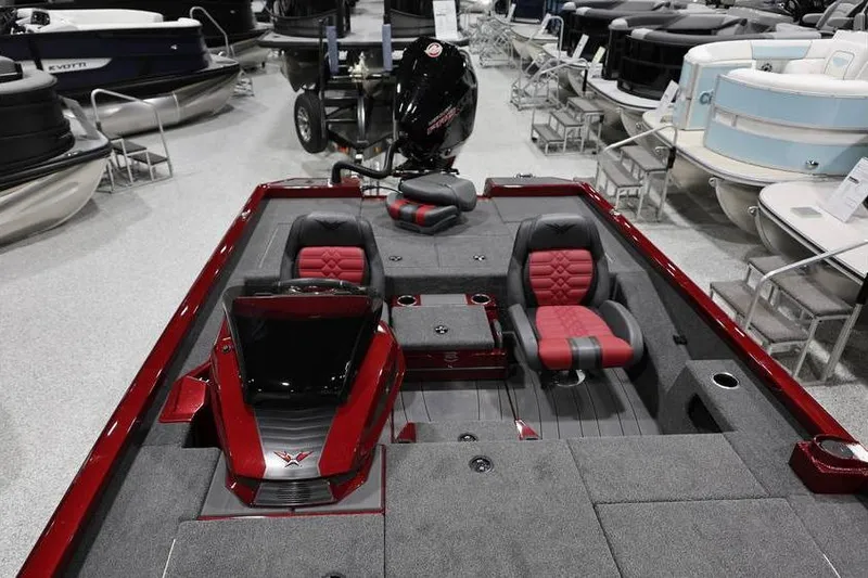Slide: The Image of 2026 Vexus AVX 2100 boat interior with red and gray seating, displayed in showroom. - 12
