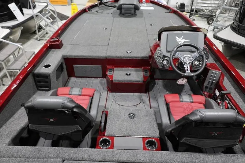 Slide: The Image of 2026 Vexus AVX 2100 boat interior with red and gray seating, steering console, and storage compartments. - 28