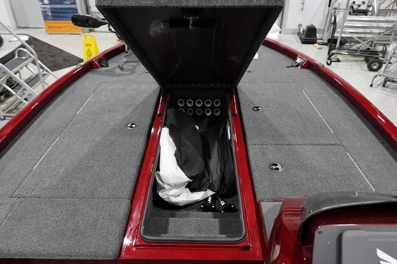 Slide: The Image of 2026 Vexus AVX 2100 boat interior with open storage compartment and gray carpeted deck. - 29