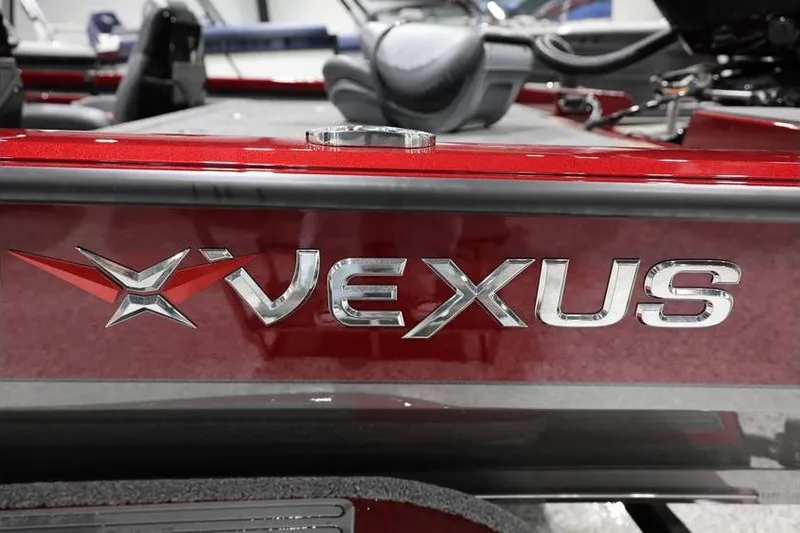 Slide: The Image of 2026 Vexus AVX 2100 boat logo on sleek red surface. - 31