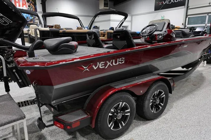 Slide: The Image of 2026 Vexus AVX 2100 boat in showroom, featuring sleek design and dual-axle trailer. - 4