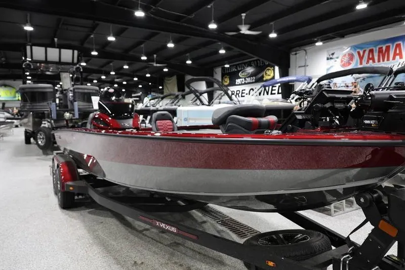 Slide: The Image of 2026 Vexus AVX 2100 boat displayed in showroom with sleek red design. - 6