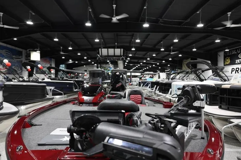 Slide: The Image of 2026 Vexus AVX 2100 boat displayed in a showroom with other boats. - 7