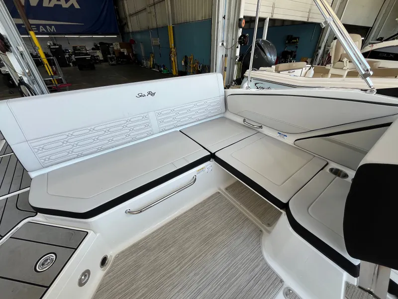 Slide: The Image of The image shows the seating area of a 2026 Sea Ray SPX 210 boat with gray upholstery. - 4