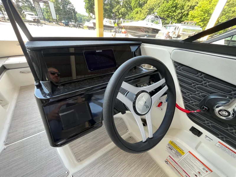 Slide: The Image of The image shows the cockpit of a 2026 Sea Ray SPX 210 boat with a modern steering wheel and display. - 5