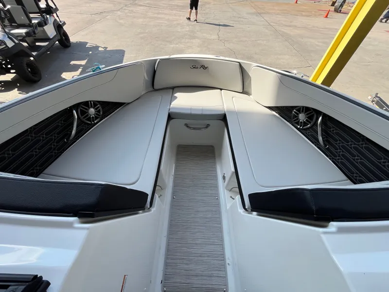 Slide: The Image of Sea Ray SPX 210 2026: Spacious bow area with cushioned seating and speakers. - 9