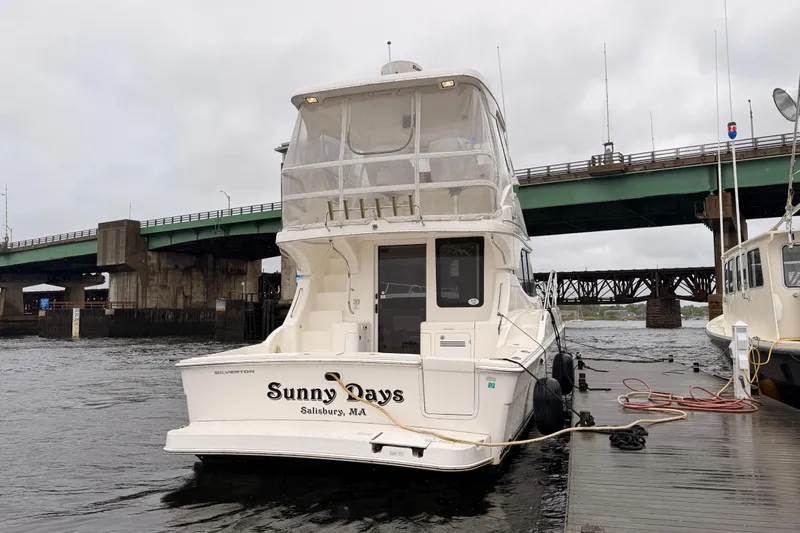 Slide: The Image of 2006 Silverton 38 Convertible yacht docked near a bridge in Salisbury, MA. - 1