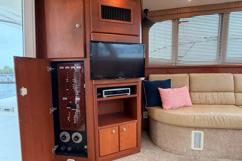 Slide: The Image of Interior of 2006 Silverton 38 Convertible yacht with TV, seating, and control panel. - 10
