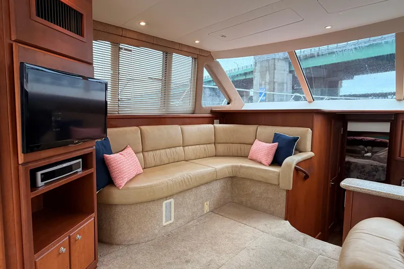 Slide: The Image of Luxurious interior of a 2006 Silverton 38 Convertible yacht with plush seating and TV. - 11