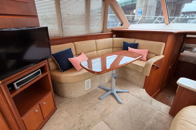 Slide: The Image of Interior of 2006 Silverton 38 Convertible yacht with cozy seating and TV. - 12