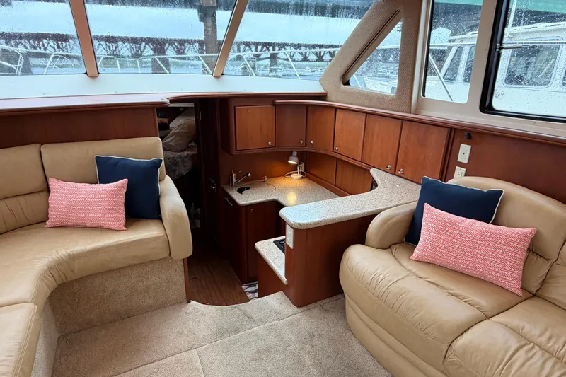 Slide: The Image of Interior of 2006 Silverton 38 Convertible yacht with beige seating and wooden cabinetry. - 13