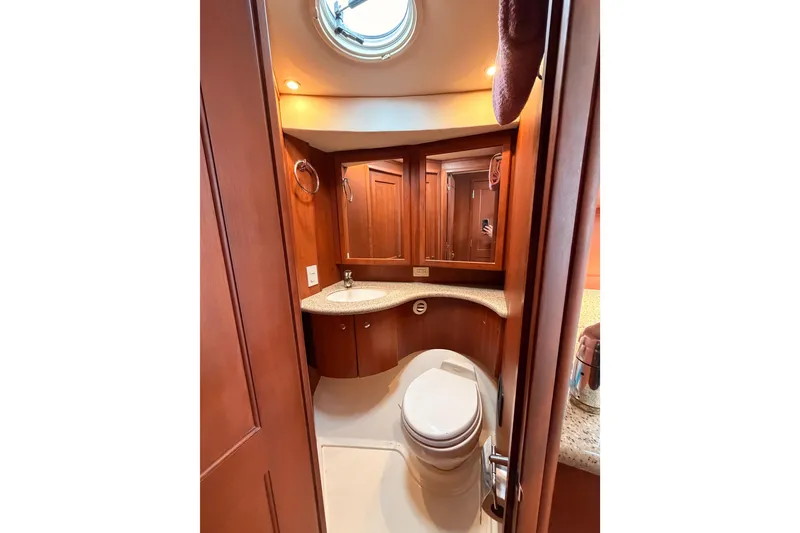 Slide: The Image of Luxurious bathroom in 2006 Silverton 38 Convertible yacht with wood cabinetry and modern fixtures. - 17