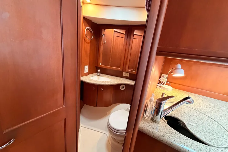 Slide: The Image of Luxurious bathroom interior of 2006 Silverton 38 Convertible yacht with wooden cabinetry. - 18