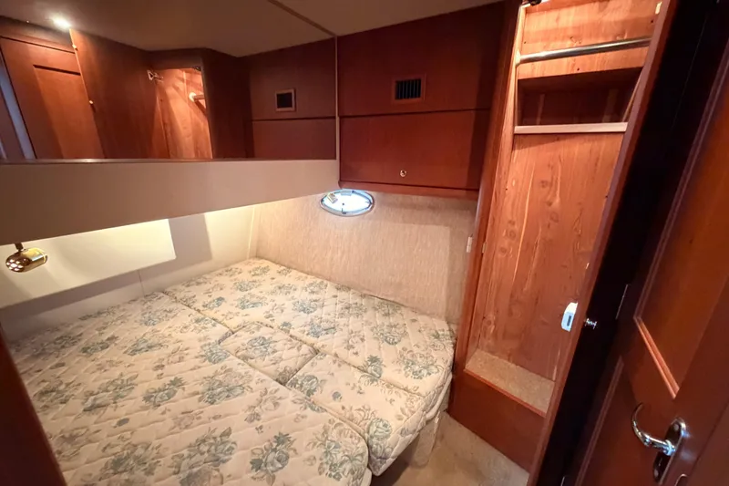 Slide: The Image of Cozy cabin interior of 2006 Silverton 38 Convertible yacht with wooden cabinetry. - 20