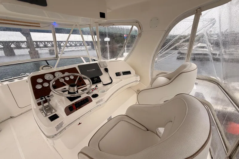 Slide: The Image of Interior helm of 2006 Silverton 38 Convertible yacht with steering wheel and controls. - 23