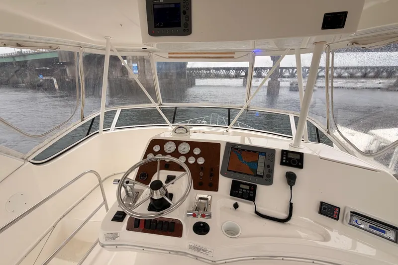 Slide: The Image of Helm of 2006 Silverton 38 Convertible yacht with navigation equipment and steering wheel. - 24