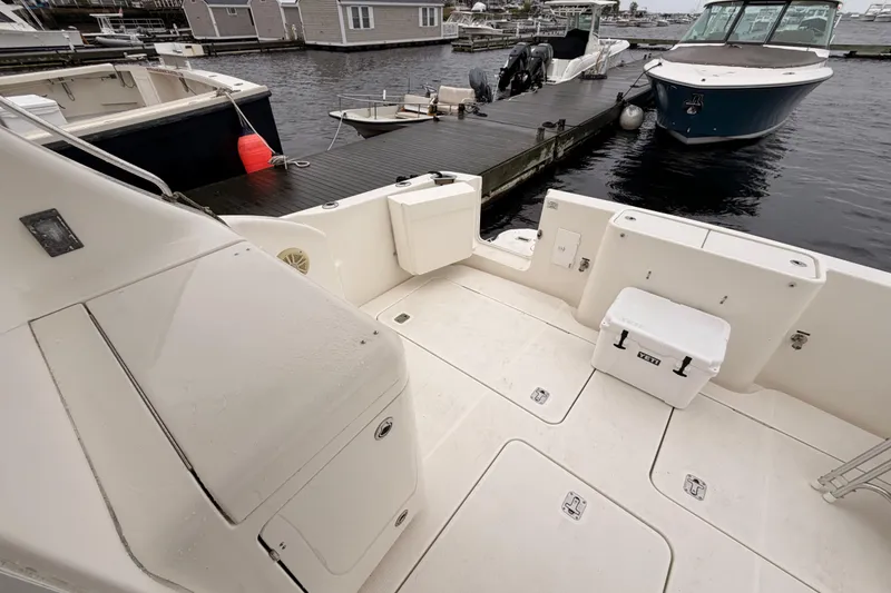 Slide: The Image of 2006 Silverton 38 Convertible boat docked, featuring spacious deck and storage compartments. - 4