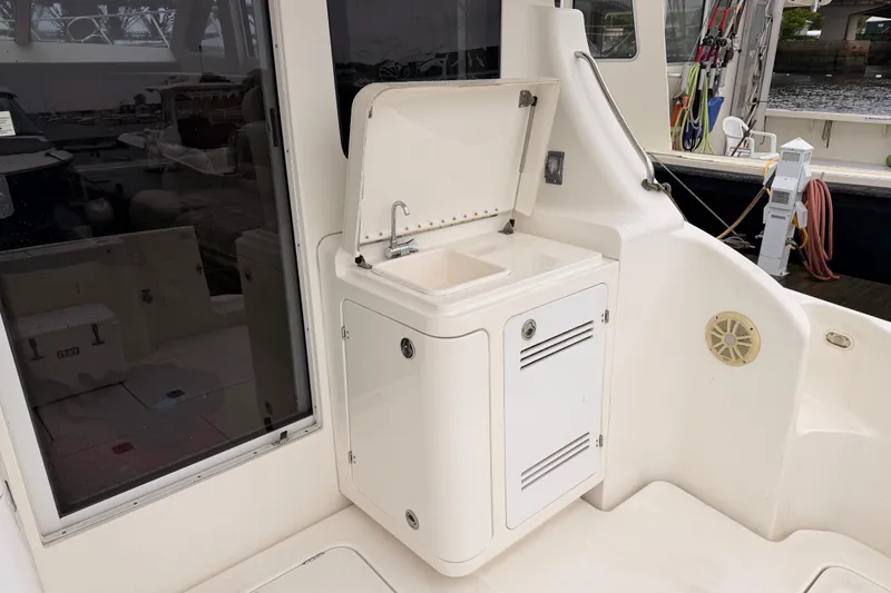 Slide: The Image of 2006 Silverton 38 Convertible yacht with outdoor sink and storage cabinet. - 5