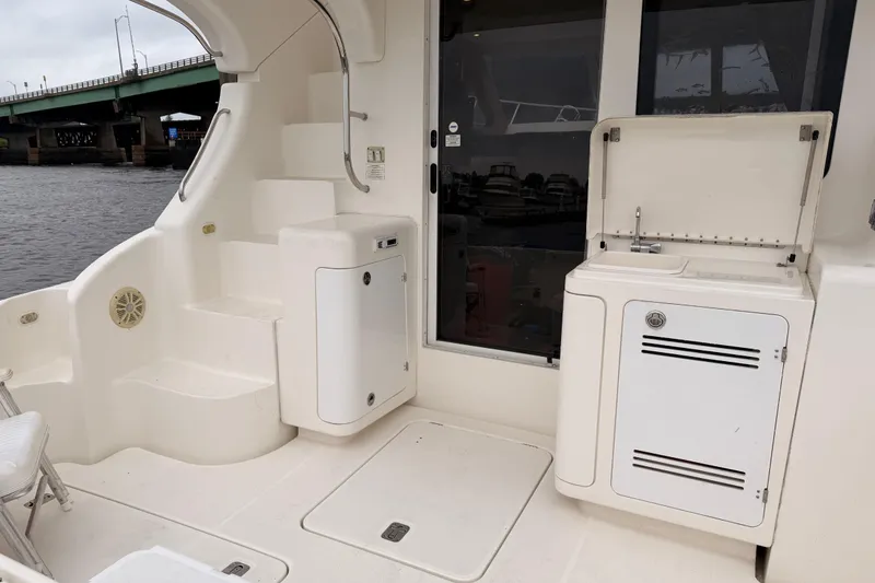 Slide: The Image of 2006 Silverton 38 Convertible yacht interior with sink and storage, near a bridge. - 6