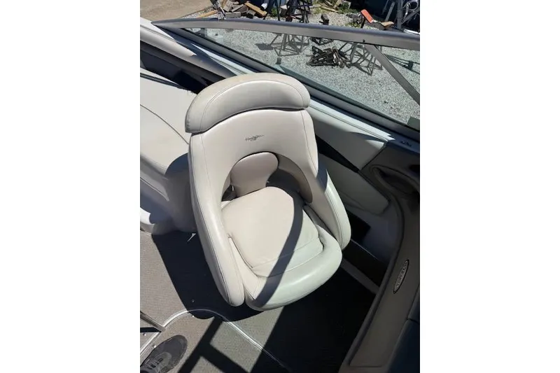 Slide: The Image of 2002 Four Winns 220 Horizon boat seat, featuring sleek white upholstery and ergonomic design. - 11