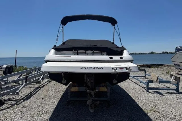 Slide: The Image of 2002 Four Winns 220 Horizon boat on trailer by the water. - 3