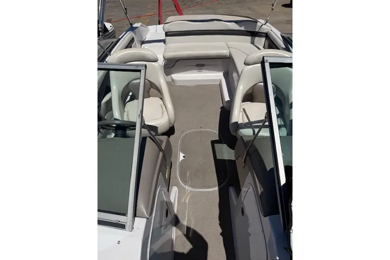 Slide: The Image of 2002 Four Winns 220 Horizon boat interior with beige seating and carpeted floor. - 5
