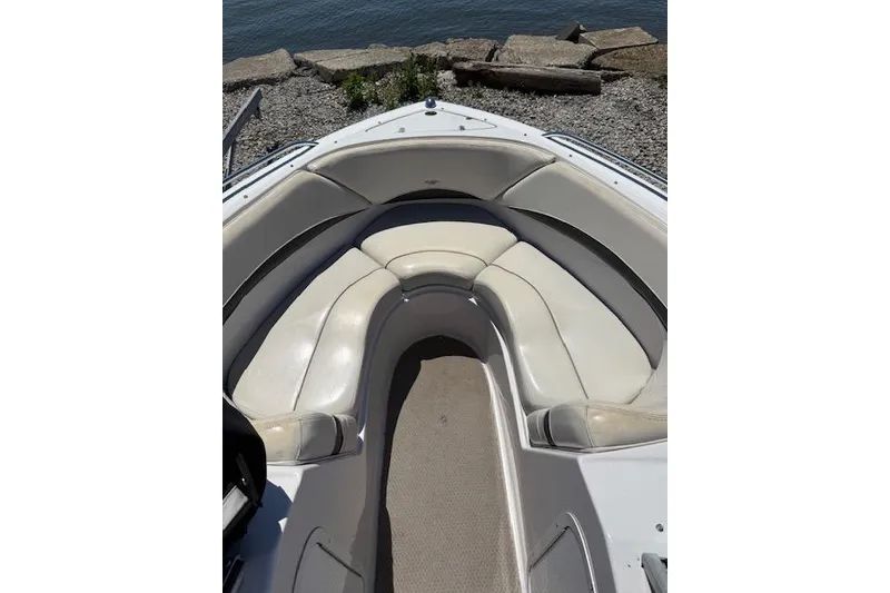 Slide: The Image of 2002 Four Winns 220 Horizon boat interior with white seating and carpeted floor. - 6