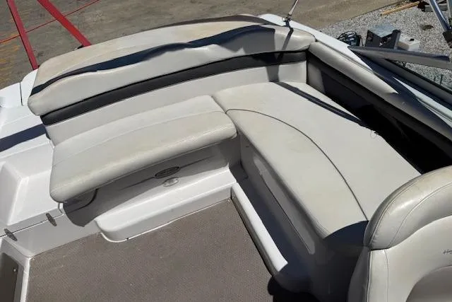 Slide: The Image of 2002 Four Winns 220 Horizon boat interior with white cushioned seating. - 9