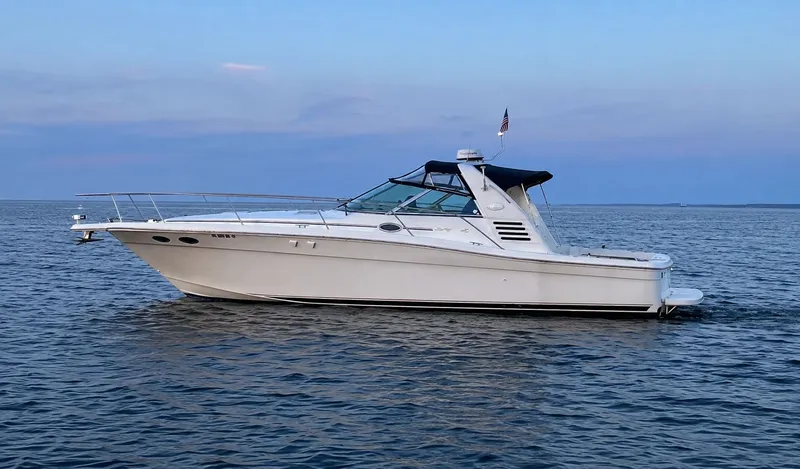 Slide: The Image of 1999 Sea Ray 370 Express Cruiser on calm waters. - 1