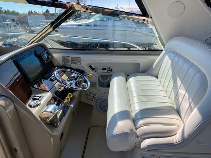 Slide: The Image of Interior of a 1999 Sea Ray 370 Express Cruiser with helm station. - 11