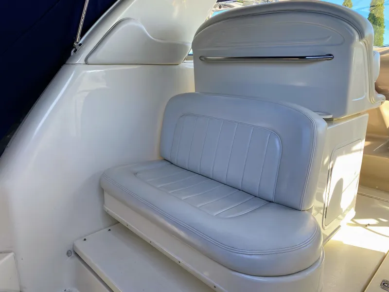 Slide: The Image of Interior of 1999 Sea Ray 370 Express Cruiser with white leather seating. - 14