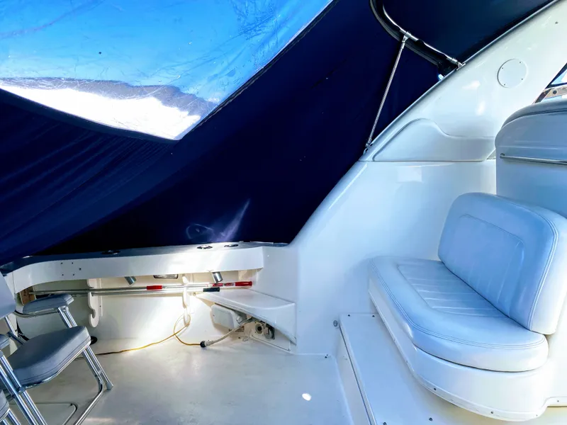 Slide: The Image of Interior of 1999 Sea Ray 370 Express Cruiser with blue canopy. - 16
