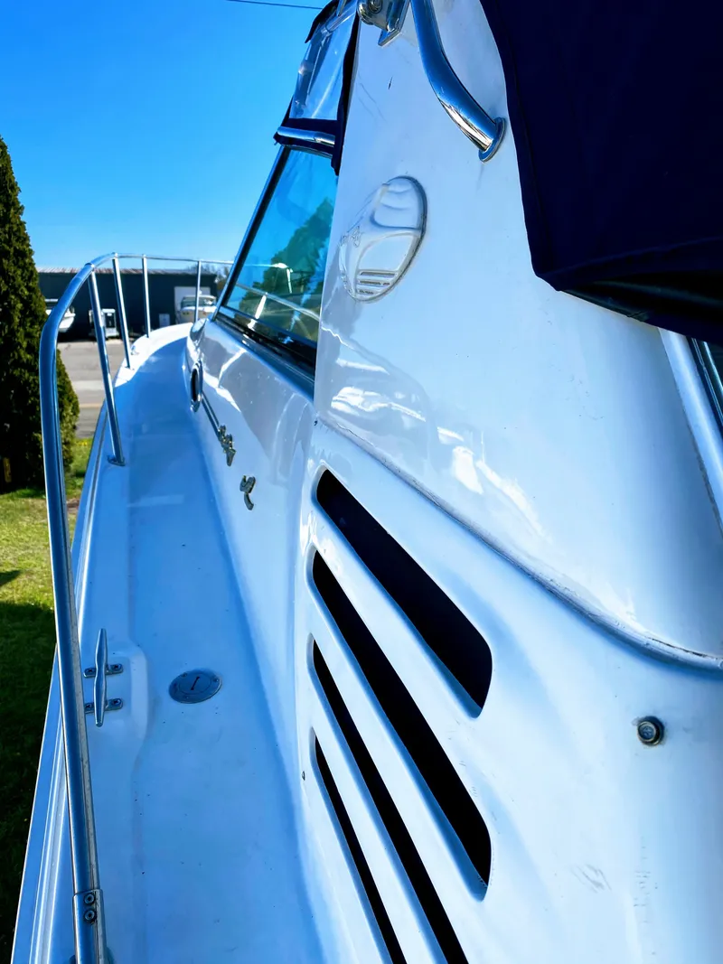 Slide: The Image of 1999 Sea Ray 370 Express Cruiser side view in sunny weather. - 3