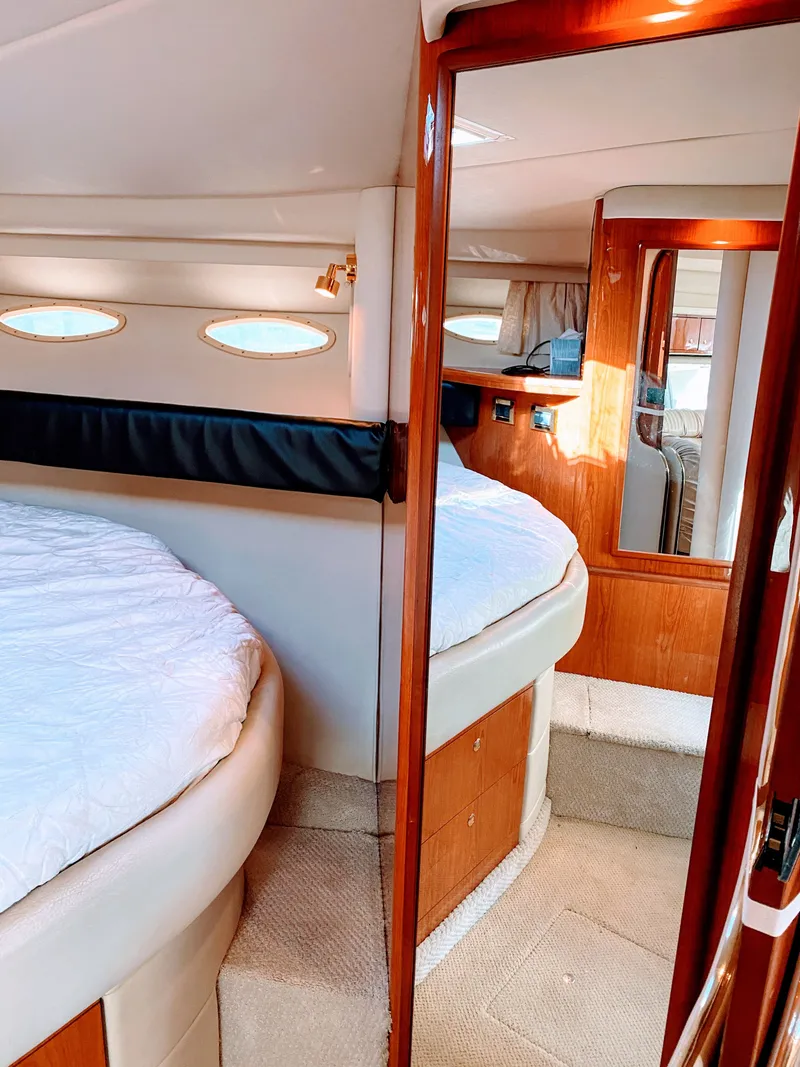 Slide: The Image of Interior of 1999 Sea Ray 370 Express Cruiser with cozy bedroom. - 35