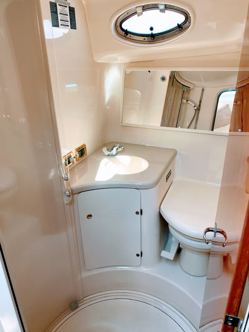 Slide: The Image of 1999 Sea Ray 370 Express Cruiser bathroom with sink and toilet. - 38