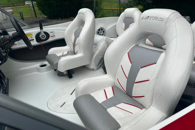 Slide: The Image of 2017 Nitro Z19 Sport boat interior with white and gray seats, steering wheel visible. - 10