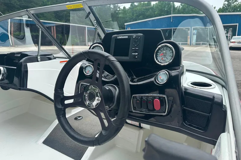 Slide: The Image of 2017 Nitro Z19 Sport boat dashboard with steering wheel and gauges. - 2