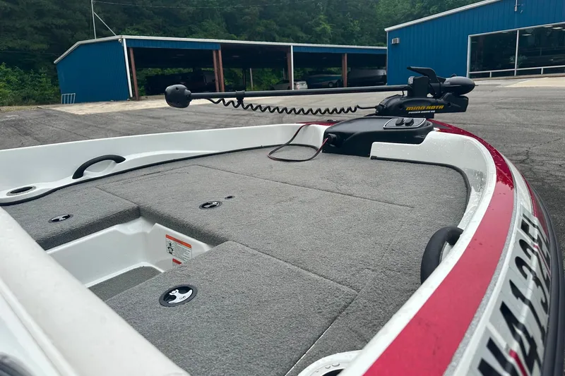 Slide: The Image of 2017 Nitro Z19 Sport boat with trolling motor, parked near blue buildings. - 5
