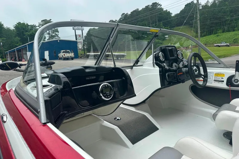 Slide: The Image of Interior of a 2017 Nitro Z19 Sport boat with steering wheel and dashboard controls. - 8