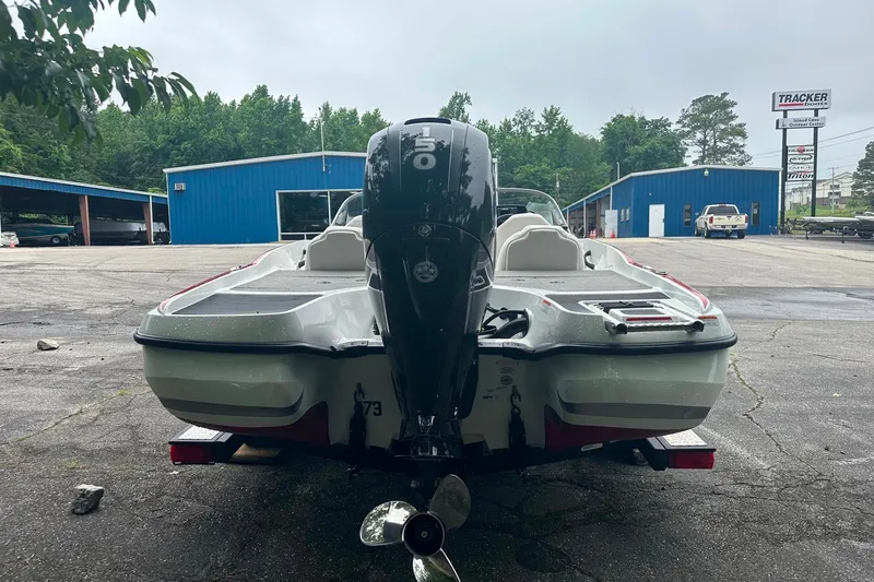 Slide: The Image of 2017 Nitro Z19 Sport boat with outboard motor in a parking lot. - 9
